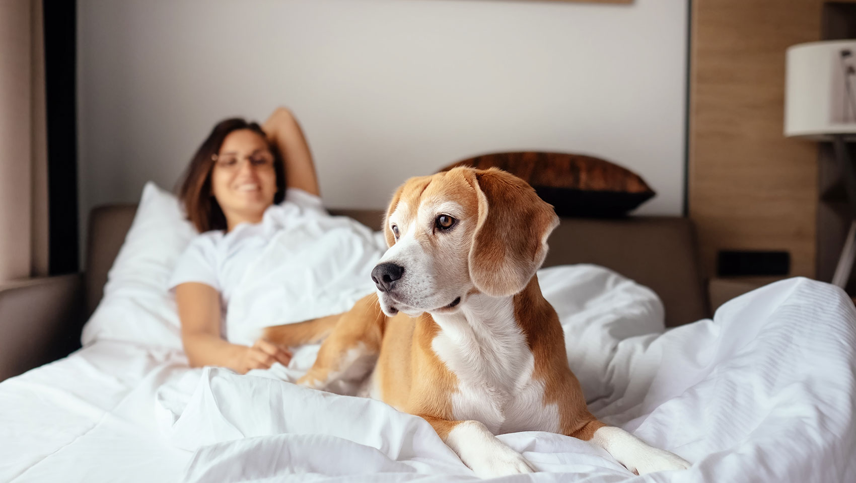woman on bed with dog