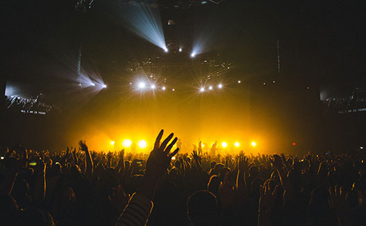 Crowd at concert with hands in the air